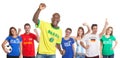 Goal celebration of a brazilian soccer fan with fans from other countries Royalty Free Stock Photo