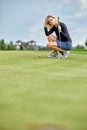 Goal concept, copy space. Women golfing time holding golf equipment on green field background. The pursuit of excellence Royalty Free Stock Photo