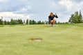 Goal concept, copy space. Women golfing time holding golf equipment on green field background. The pursuit of excellence Royalty Free Stock Photo