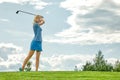 Goal concept, copy space. Women golfing time holding golf equipment on green field background. The pursuit of excellence Royalty Free Stock Photo