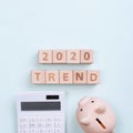 2020 goal, finance plan abstract design concept, wood blocks on green table background with piggy bank and calculator, top view, Royalty Free Stock Photo