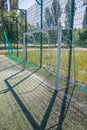 Goal on a football field with artificial green grass near the school. Amateur football field. Sunny summer day Royalty Free Stock Photo