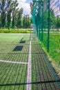 Goal on a football field with artificial green grass near the school. Amateur football field. Sunny summer day Royalty Free Stock Photo