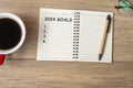 2024 GOAL with notebook, black coffee cup and pen on wood table, Top view and copy space. Happy New Year, Resolution, To do list, Royalty Free Stock Photo