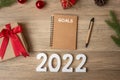 2022 GOAL with notebook, Christmas gift and pen on wood table. Xmas, Happy New Year, Resolution, To do list, start, Strategy and