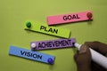 Goal, Plan, Achivement, Vision text on sticky notes isolated on green desk. Mechanism Strategy Concept