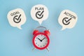 GOAL, PLAN, ACTION word of real white speech bubble paper cut with red analog clock on blue background Royalty Free Stock Photo