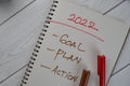 2022 - Goal, Plan, Action write on a book isolated on Wooden Table