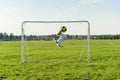 Goalie catching football ball saving goal Royalty Free Stock Photo