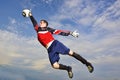 Goalie jumps to catch soccer ball Royalty Free Stock Photo