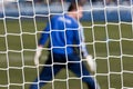 Goalkeeper behind football net Royalty Free Stock Photo