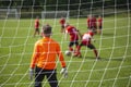 Goalkeeper catches the ball.