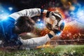 Goalkeeper catches a fast fiery soccer ball Royalty Free Stock Photo