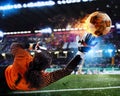 Goalkeeper catches the fireball in the stadium during a football game.