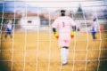 Goalkeeper through a football goal net Royalty Free Stock Photo