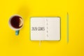 2020 goals banner. Notebook, pencil and cup of tea on a yellow background Royalty Free Stock Photo
