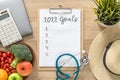 2022 goals on clipboard note pad for new year reminder list of yearly planner, health plan for work-life balance on desk Royalty Free Stock Photo