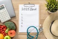 2021 goals on clipboard note pad for new year reminder list of yearly planner, health plan for work-life balance on desk Royalty Free Stock Photo