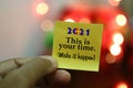 2021 Goals concept- This is your time. Make it happen. New year inspirational motivational quote on a sticky note paper in hand