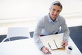 Goals are dreams with a plan and a deadline. Portrait of a businessman sitting with his cellphone and notebook at his