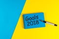 Goals 2018. Life and business goal, plan and resolutions concept for new year concept. Text on note at blue and yellow