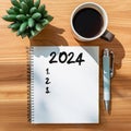 2024 goals list with notebook, coffee cup, plant on wooden background. Resolutions, plan, goals, action, strategy