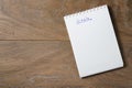 Goals list on notepad on wood table