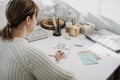 2022 goals, New year resolution. Woman in white sweater writing Text New year resolution in open notepad on the table Royalty Free Stock Photo