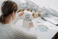 2022 goals, New year resolution. Woman in white sweater writing Text New year resolution in open notepad on the table Royalty Free Stock Photo