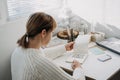 2022 goals, New year resolution. Woman in white sweater writing Text 2022 goals in open notepad on the table. Start new Royalty Free Stock Photo