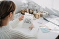 2022 goals, New year resolution. Woman in white sweater writing Text 2022 goals in open notepad on the table. Start new Royalty Free Stock Photo