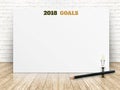 2018 goals of new year on white paper poster on wood plank floor