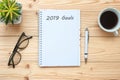 2019 Goals with notebook, black coffee cup, pen and glasses on table, Top view and copy space. New Year New Start, Resolution, Sol Royalty Free Stock Photo