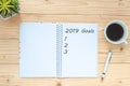 2019 Goals with notebook, black coffee cup, pen and glasses on table, Top view and copy space. New Year New Start, Resolutions, So Royalty Free Stock Photo