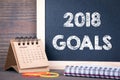 2018 goals. paper calendar and chalkboard on a wooden table Royalty Free Stock Photo