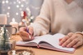 Goals plans make to do and wish list for new year christmas concept, girl writing in notebook. Woman hand holding pen on Royalty Free Stock Photo