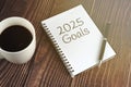 2025 Goals text on notepad and cup of coffee