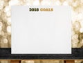2018 goals on white paper poster on black marble table with gold