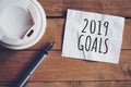 Goals for 2019 word on paper with pen and coffee cup on wooden table. Business concept Royalty Free Stock Photo