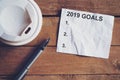 Goals for 2019 word on paper with pen and coffee cup on wooden t Royalty Free Stock Photo