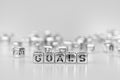 Goals word written on silver cube with black and white bokeh cu