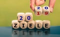 Goals for the year 2020. Hand turns dice and changes the German expression `2019 ziele` goals to `2020 Ziele` Royalty Free Stock Photo