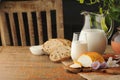 Goat cheese with condiments, bread and jug of milk on wooden tab Royalty Free Stock Photo