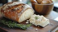 Goat cheese with rosemary and fresh loaf. Royalty Free Stock Photo