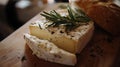 Goat cheese with rosemary and fresh loaf. Royalty Free Stock Photo