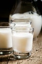 Goat milk in glasses, vintage wooden background, selective focus Royalty Free Stock Photo