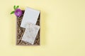 Goat milk soap in a cardboard box. Flat composition with handmade soap on a yellow background Royalty Free Stock Photo