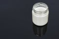 Goat milk yogurt in glass jar on a black background. Royalty Free Stock Photo