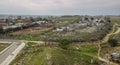 Goatherd walks with herds of goats through countryside