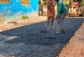 Male workers build road with asphalt